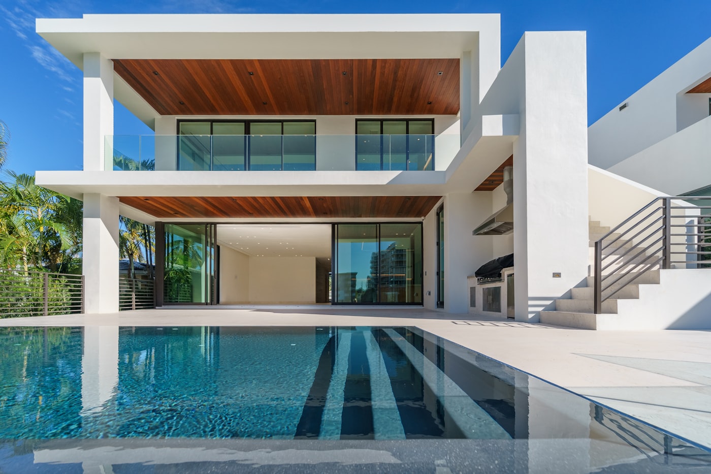 A white cubic villa with a pool